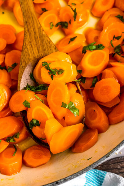 Easy to make glazed carrots served on a wooden spoon.