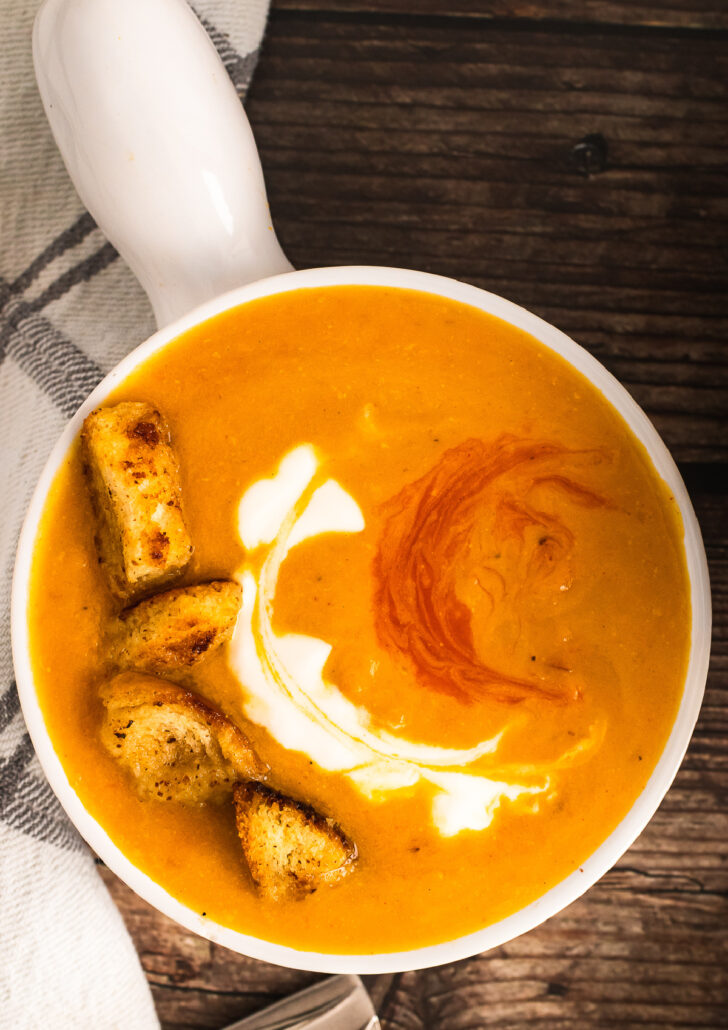 Roasted Sweet Potato Soup in a white bowl with a handle.