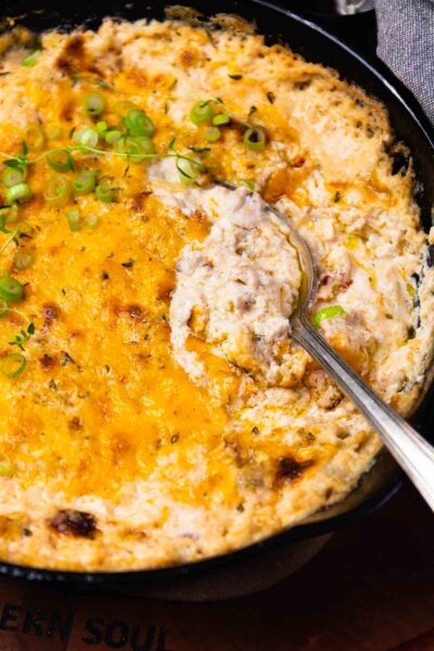 Spoon in Crab Dip cooked in cast iron.
