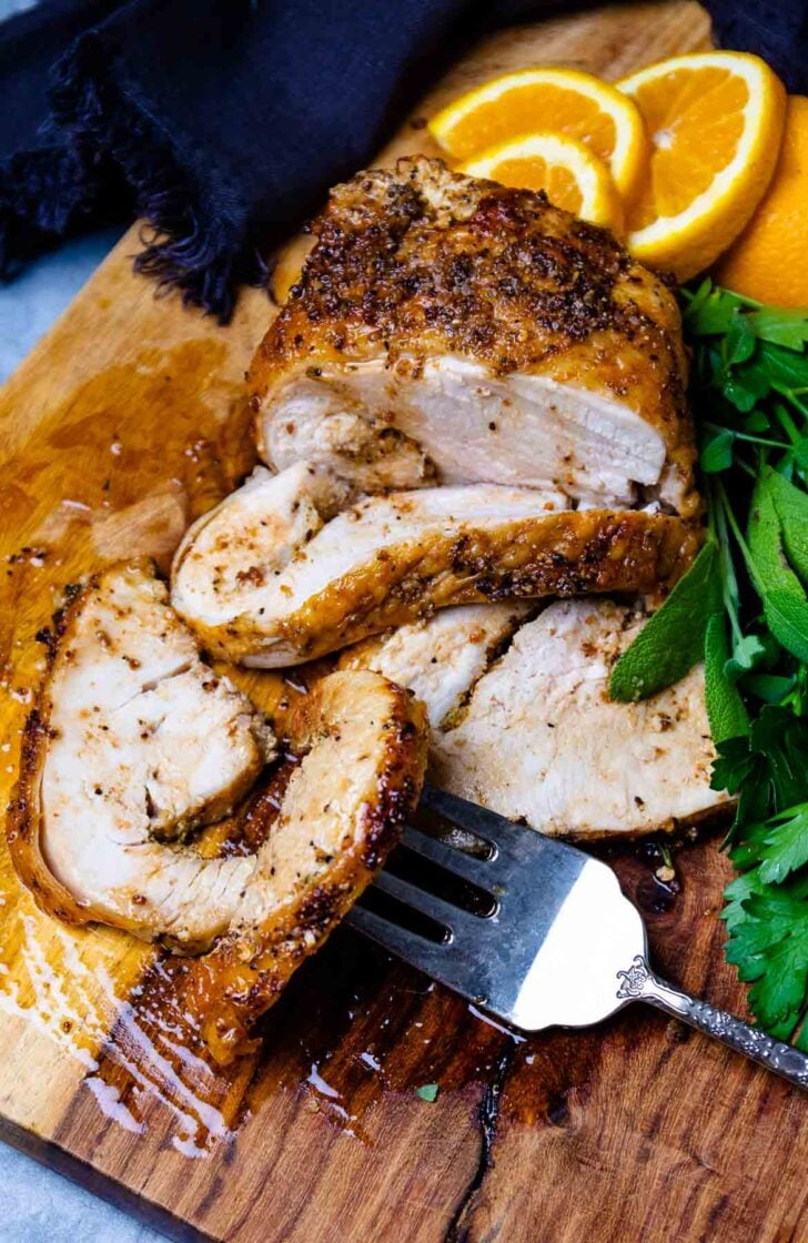 Air Fryer Turkey Breasts on a cutting board with a silver fork