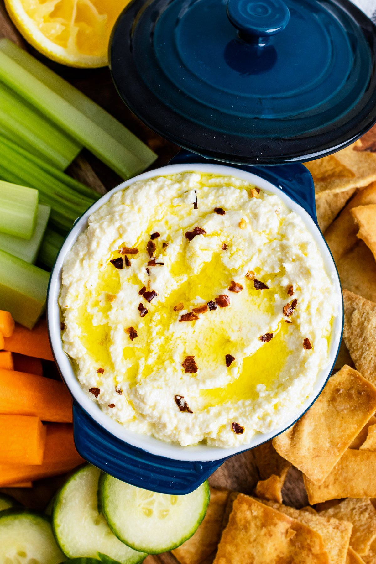 Blue bowl with Whipped Feta with olive oil and red pepper flakes.