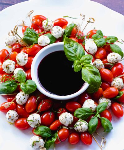 Christmas Caprese Wreath Salad with balsamic reduction served for the holidays.