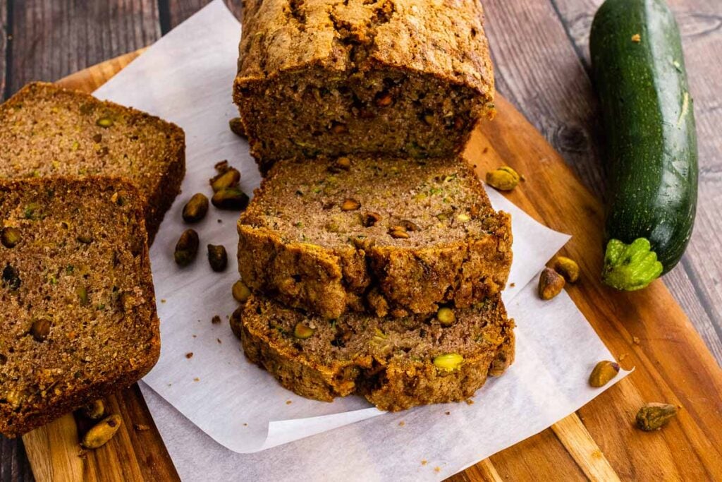 Sliced baked Zucchini Bread on a cutting board.