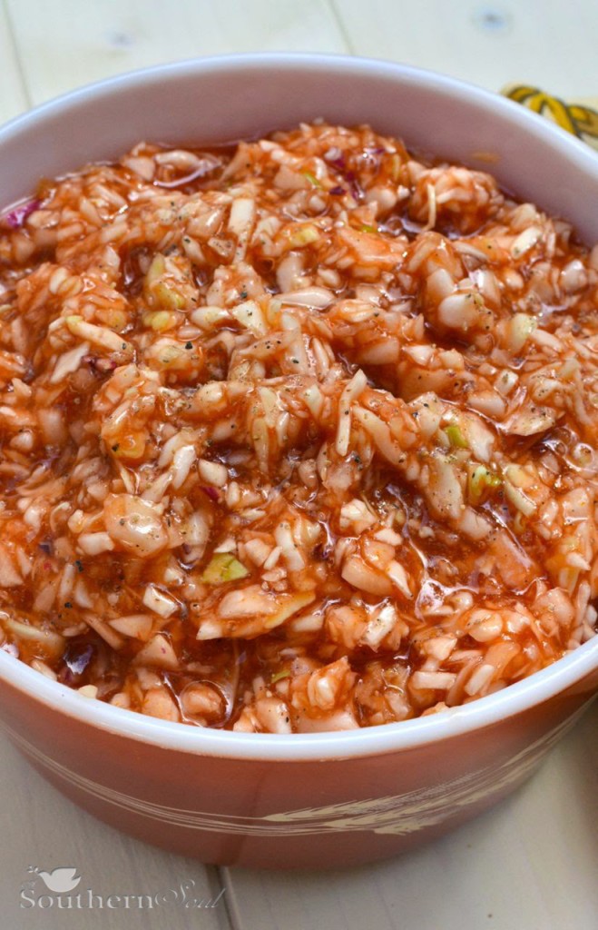 Finely chopped cabbage, tangy apple cider vinegar, sweetness from sugar, then pepper along with a dash of hot sauce make this one special BBQ Red Slaw recipe!