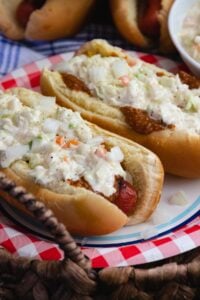 Carolina Slaw Dogs are loaded with flavor! Made with hot dogs in buns, mustard, chili, onions and creamy coleslaw.