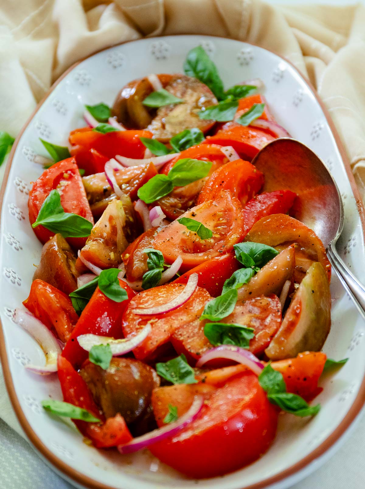 Fresh tomato Salad with basil and red onion is one of summers best side dished served with anything off the grill or just on it's own.