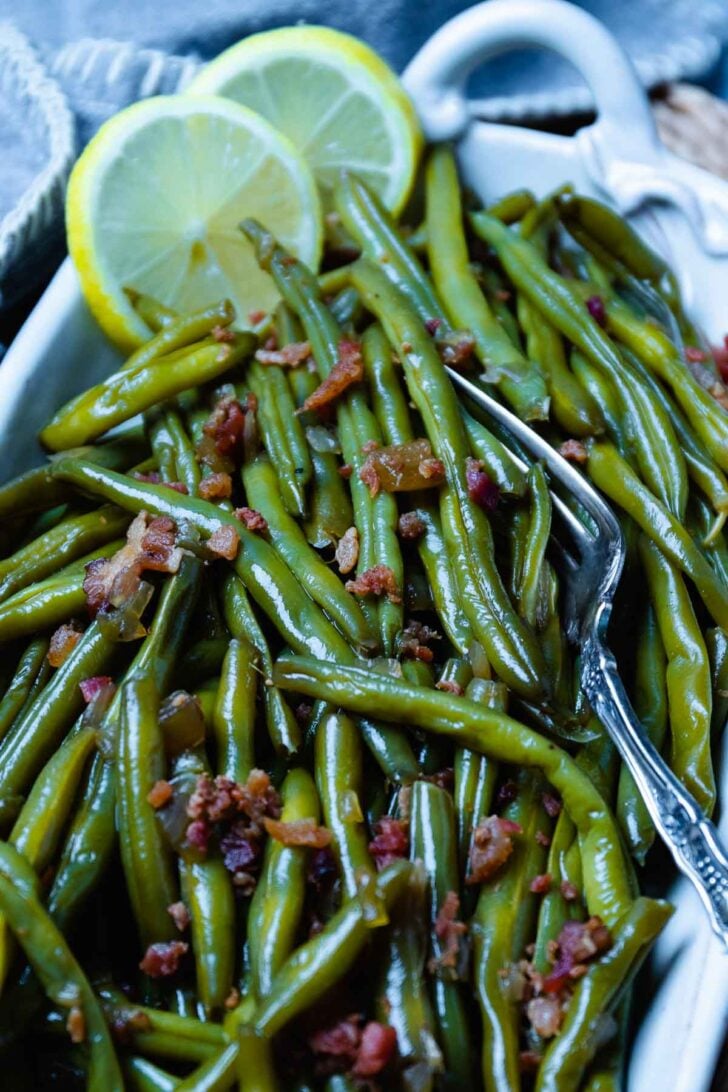Crock Pot Green Beans served in a white bowl with a silver fork.