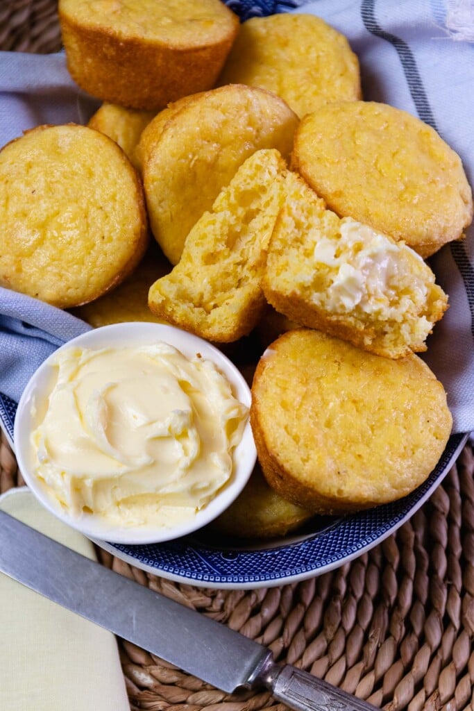 दोपहर के भोजन या रात के खाने के लिए नीले कटोरे में गर्म करके मक्खन के साथ कॉर्न मफिन परोसा जाता है।