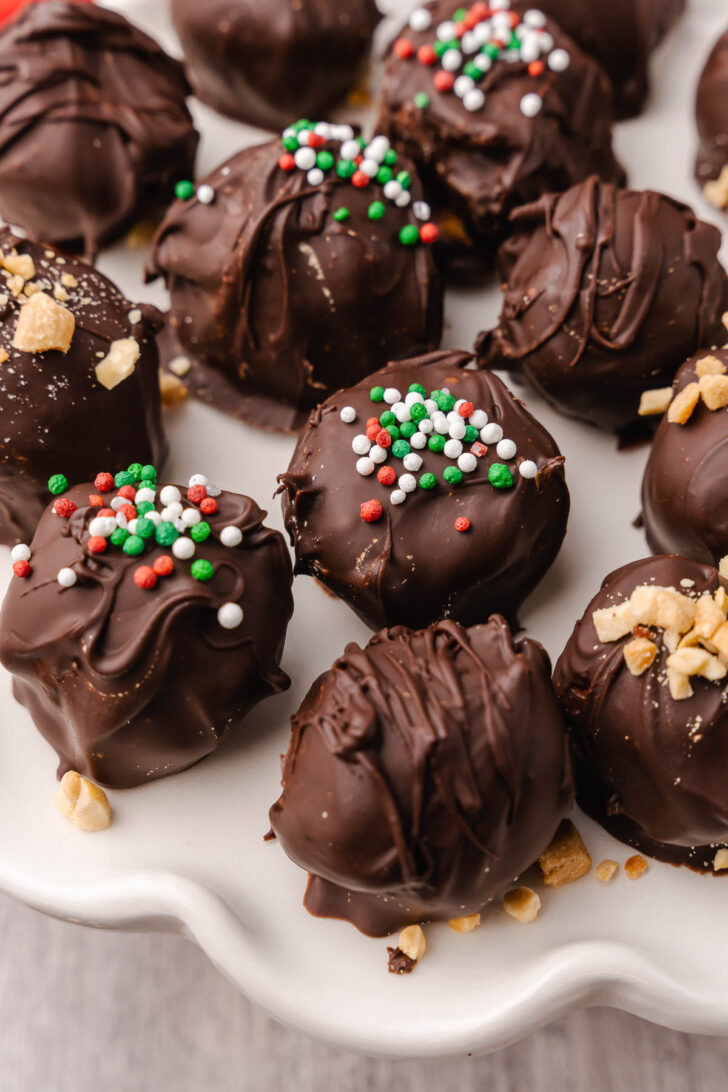 Peanut Butter Balls topped with a drizzle of chocolate and crushed peanuts make a wonderful sweet treat for the holidays and are perfect for gift giving.