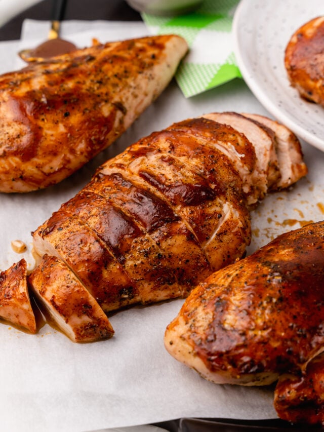 Tender, and juicy oven baked chicken with a rich BBQ sauce with all the flavors you love from summer grilling is easy to make and the perfect weeknight meal.