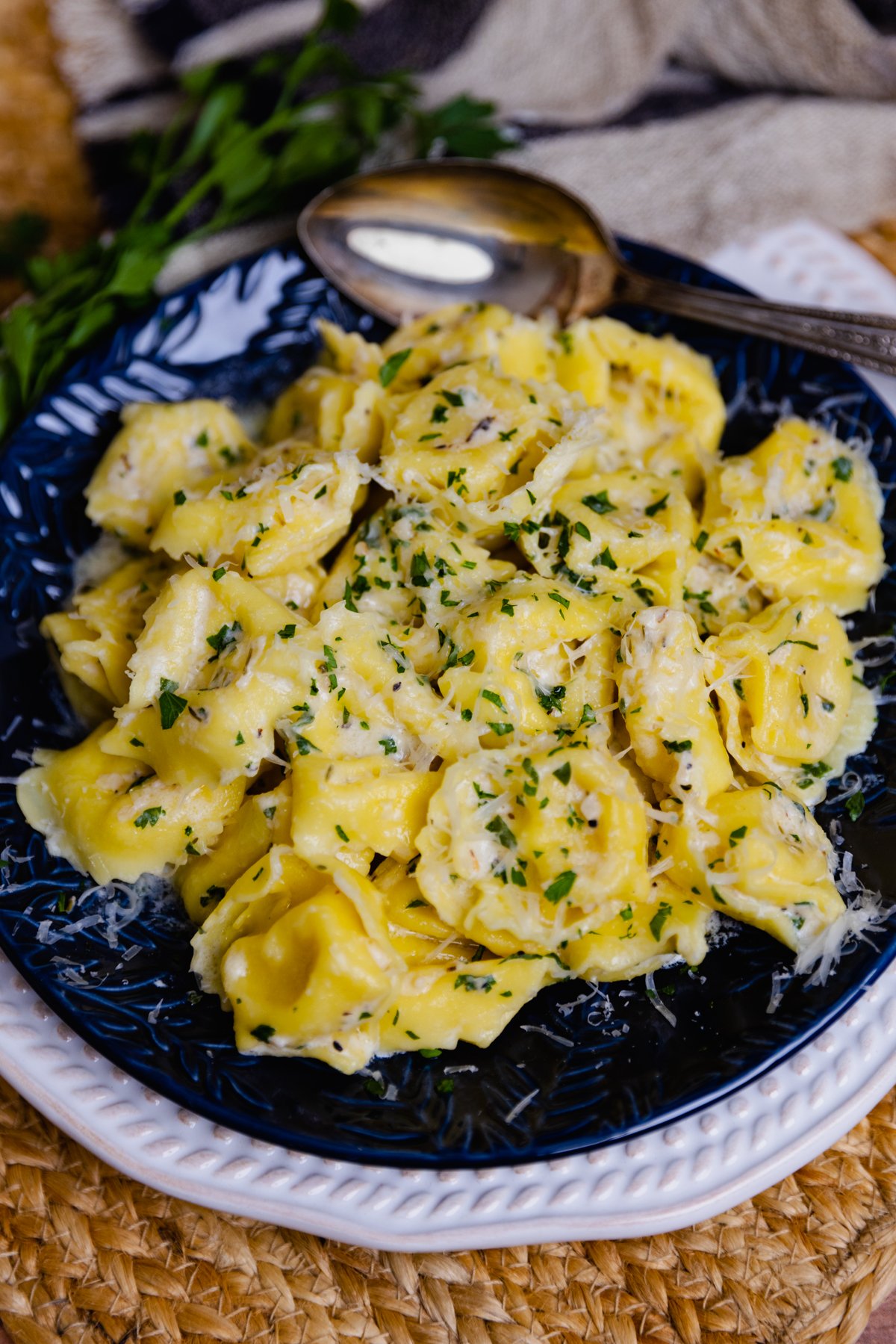 Creamy Cheesy Tortellini made on the stovetop is full of garlic, and herbs with a macaroni and cheese vibe making it a wonderful side dish!