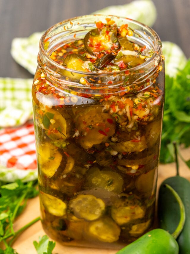 Sweet Heat Pickles marinated in red pepper, sugar, garlic, parsley and jalapeños are crazy delicious and so easy to make. They are great as a snack, with burgers, chicken, and perfect for a charcuterie board!
