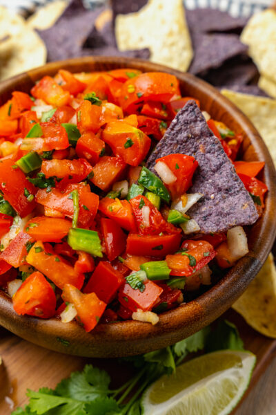 Homemade fresh pico de gallo with tomatoes, onions, jalapeno, cilantro and lime served with chips is a great appetizer and also makes a terrific topping for chicken, beef or fish!