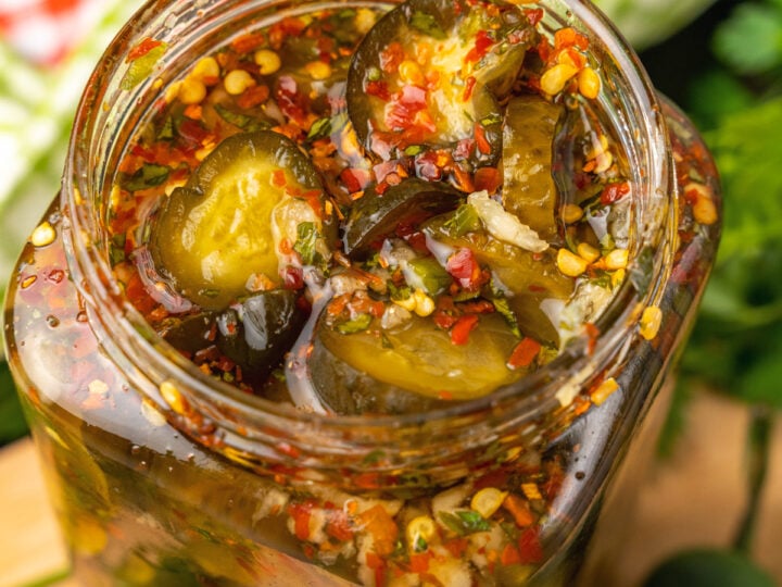 Jar or Sweet Heat Pickles marinated in red pepper, sugar, garlic, parsley and jalapeños are crazy delicious and so easy to make. They are great as a snack, with burgers, chicken, and perfect for a charcuterie board!