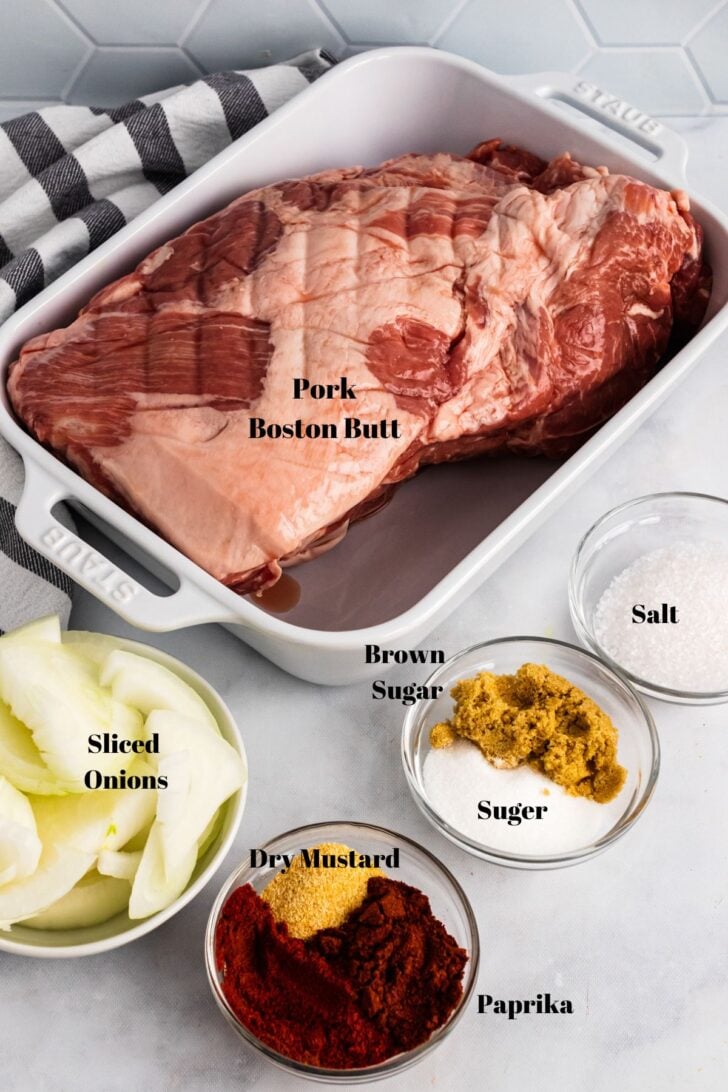 Pork Boston Butt, sliced onions, dry mustard, paprika, sugar, brown sugar, salt in containers for Crock Pot Pulled Pork.