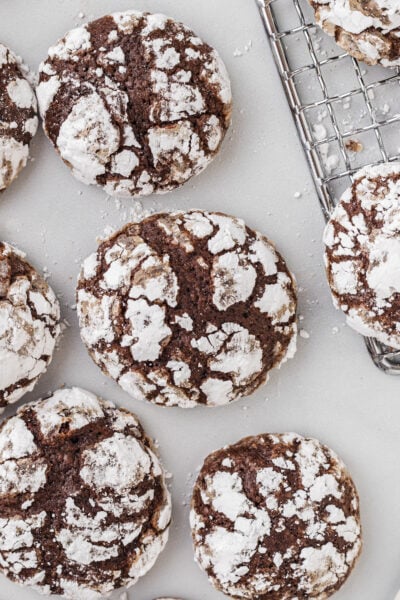 Crinkle cookies sitting on a table near a wire rack.