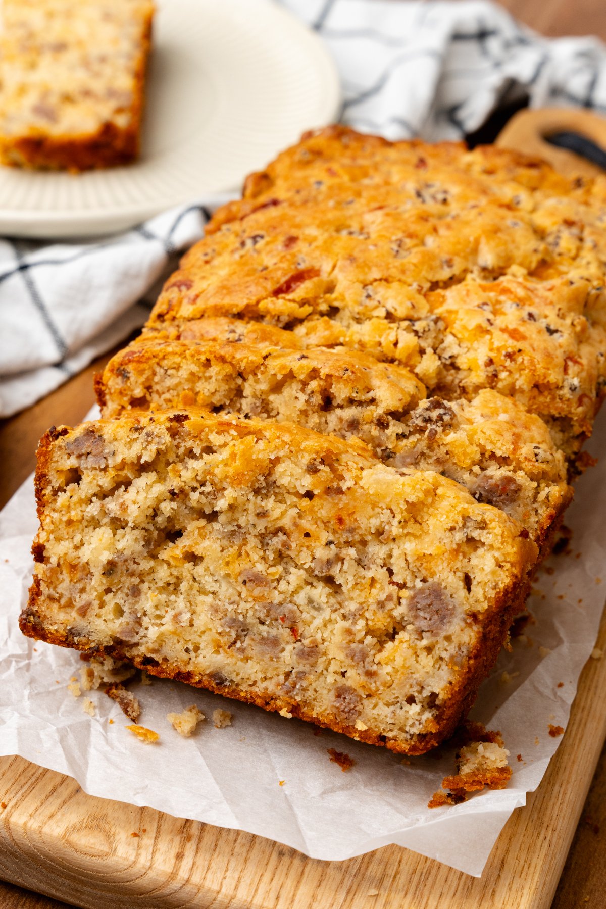 Sausage cheese bread cut into slices on top of a cutting board.