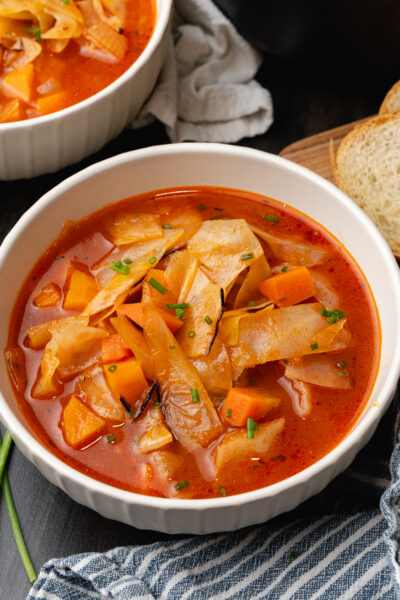 White bowl filled to the top with cozy cabbage soup.