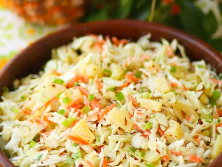 Pineapple Slaw is made with pineapple chunks, bagged cabbage, sliced almonds and green onions with a light, sweet dressing is a side dish that is great for any occasion!