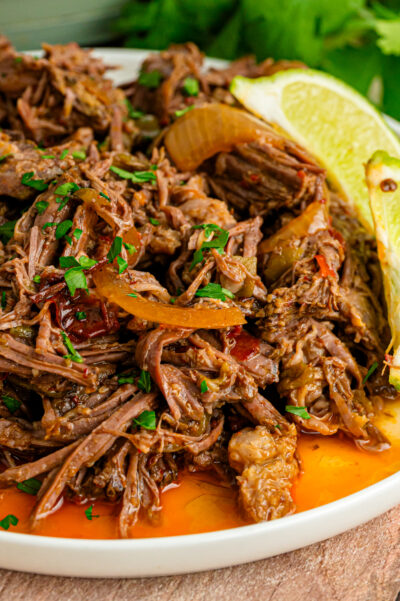 Crock Pot Shredded Mexican Beef served with limes is easy to make and great for so many dishes!
