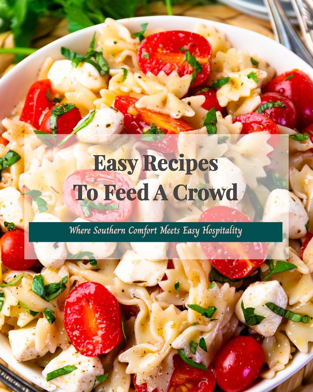 Pasta salad with tomatoes and mozzarella with a title overlay for easy recipes to feed a crowd