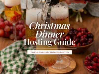 Champagne being poured into flutes with fresh cranberries, surrounded by bowls of cranberries and a green gingham napkin, with the title ‘Christmas Dinner Hosting Guide.’