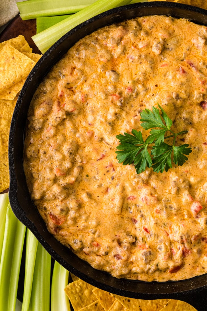 Warm pimento cheese sausage dip in a skillet, creamy and melted, served with tortilla chips for dipping.