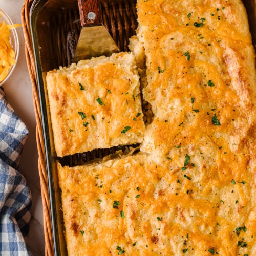Creamy Southern baked cheese grits in a casserole dish with a golden cheesy top, a classic brunch side.