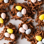 Overhead view of no-bake bird's nest cookies arranged on a serving plate for Easter dessert.