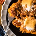 A serving of million dollar sweet potatoes on a plate showing the creamy filling and crunchy topping.