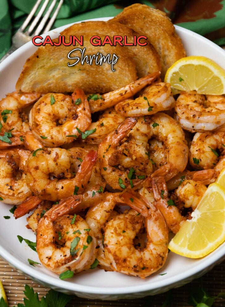 Cajun garlic shrimp on white plate with lemon wedges and buttered toast, garnished with parsley, Pinterest pin for My Easter Menu: Every Rec
