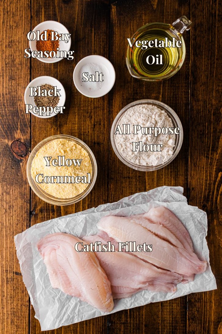 Ingredients for Southern fried catfish, including catfish fillets, yellow cornmeal, flour, Old Bay seasoning, salt, pepper, and oil.