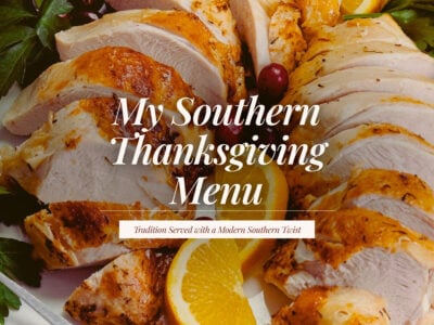 Sliced roasted turkey breast arranged on a platter with orange slices, fresh parsley, and cranberries, with the title ‘My Southern Thanksgiving Menu.’