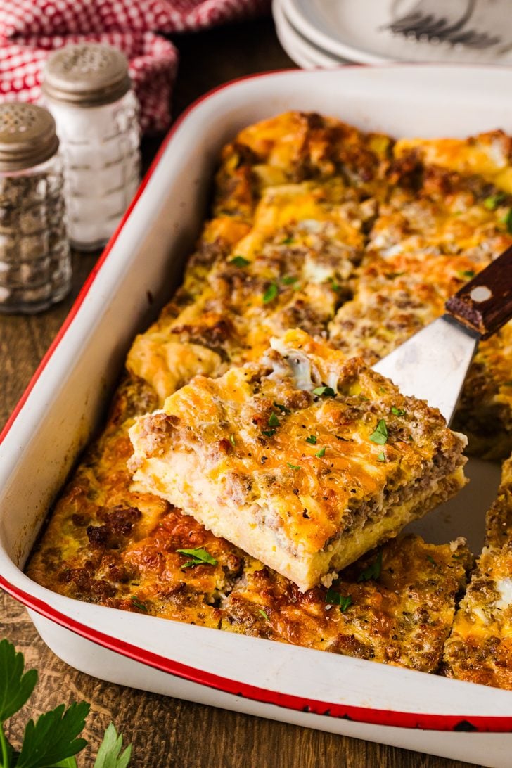 Baked sausage egg and cheese breakfast casserole in a casserole dish cut into squares.